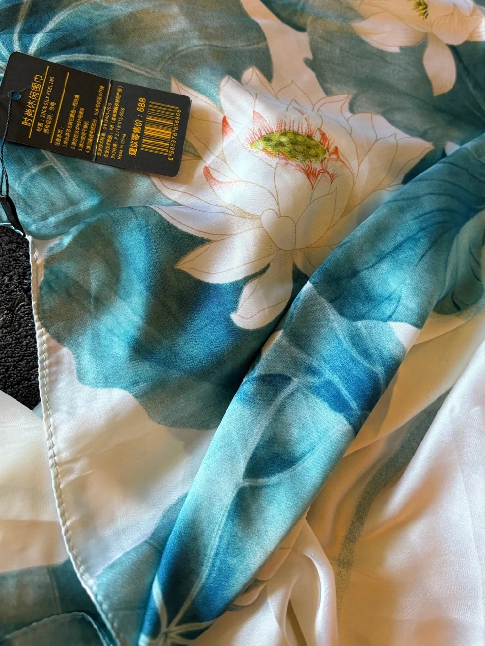 New Jinayin scarf white lotus flower design set against a teal blue beautiful